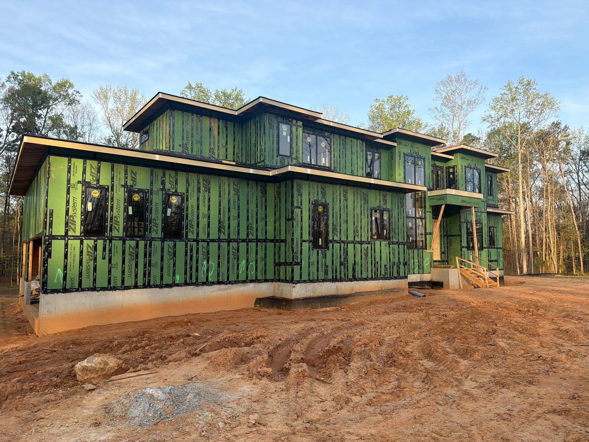 1107 Vision Path front elevation during construction, with windows installed and exterior sheathing exposed, Concord NC
