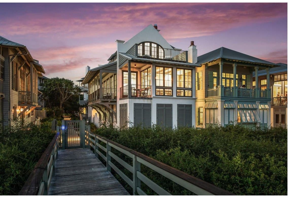 Inspiration imagery for The Preserve — a boardwalk leading to porched homes along the street at dusk